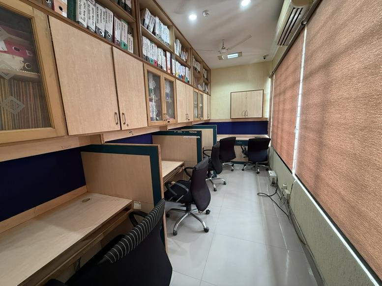 Workspace at SCO 18 first floor, Panchkula featuring wooden cubicles, overhead storage, and rolling chairs.
