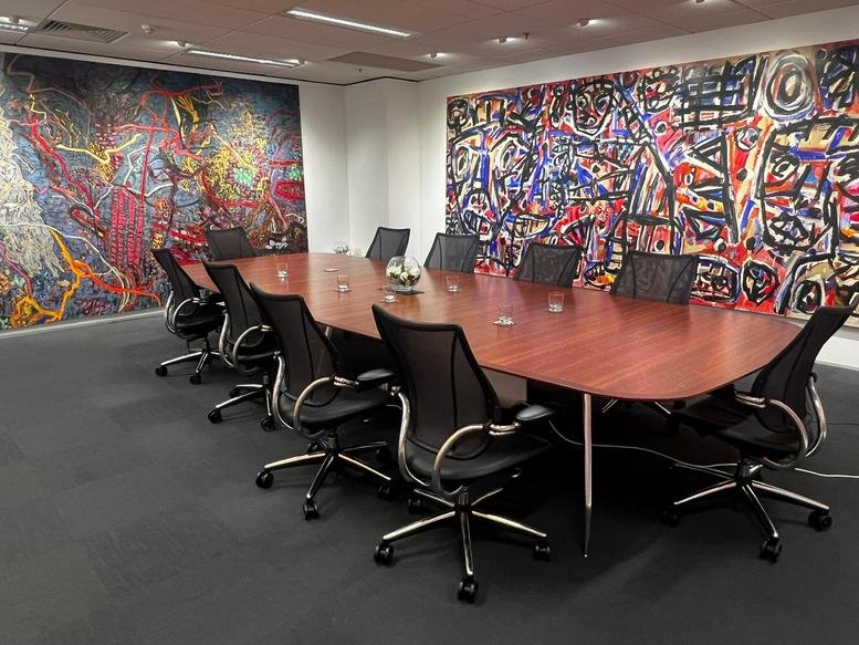 Large meeting room at 140 Bourke Street featuring vibrant abstract wall murals.