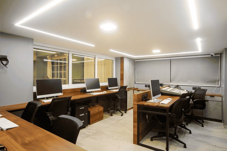 Spacious professional workspace at Recreate Spaces, 306 Mohid Heights, featuring wood-topped desks and monitors.