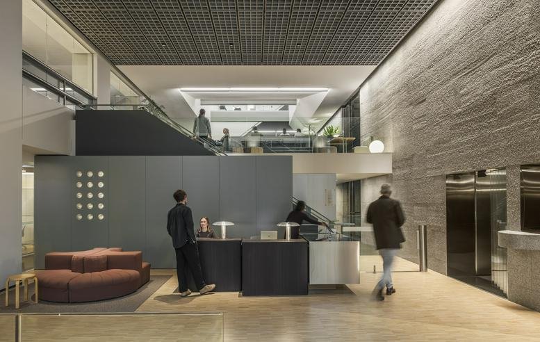 The lobby and reception at The Commons, 55 Collins Street, Melbourne CBD, Victoria with high textured concrete walls.