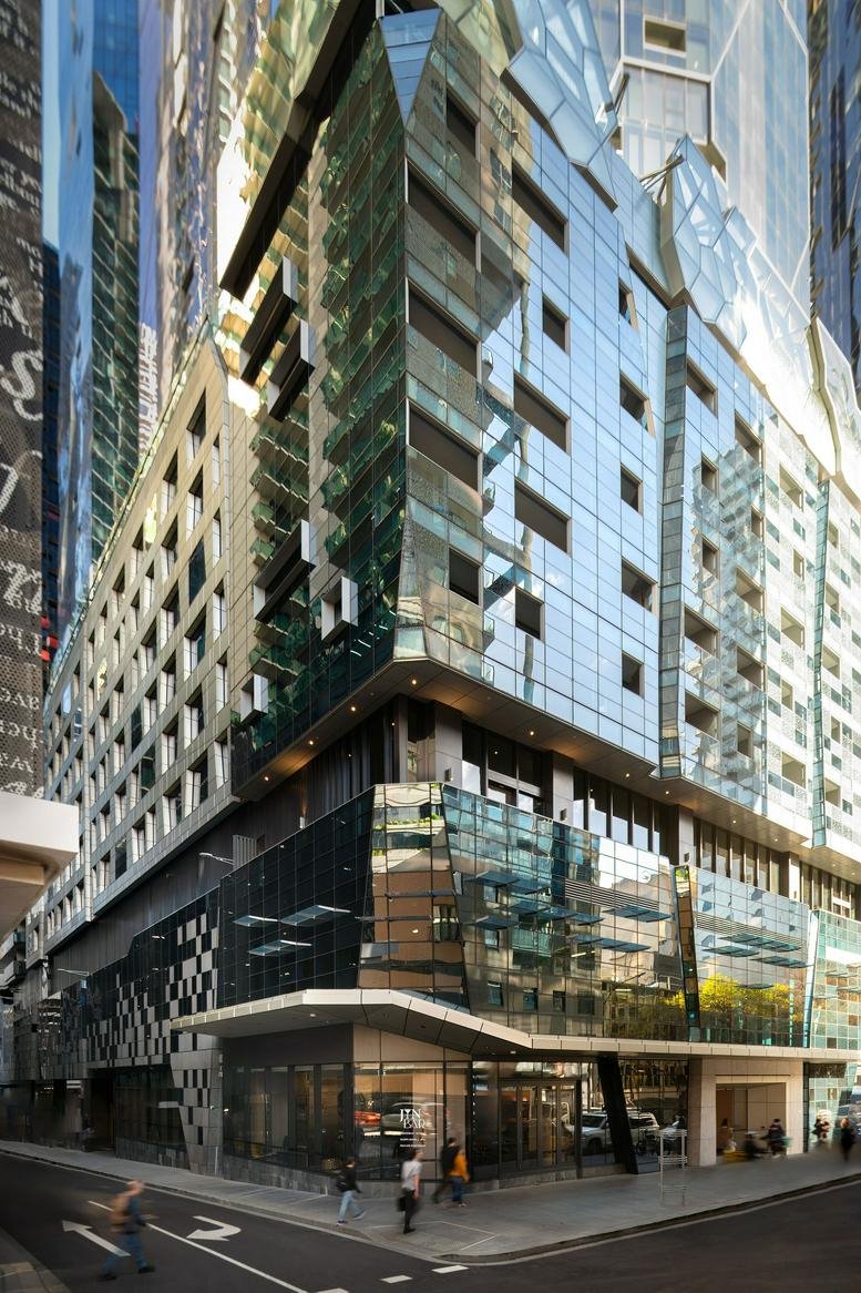 Modern glass facade of the Dorsett Melbourne building at 615 Little Lonsdale Street.