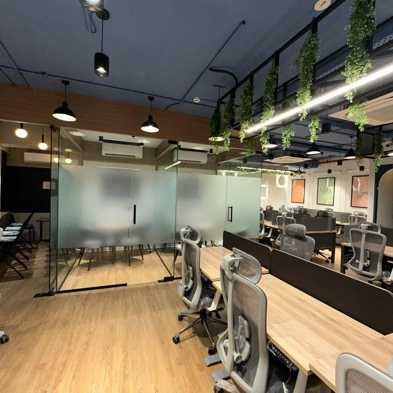 Open-plan office area at Skyblu 72 Corp, Suite 505, Mumbai, featuring hanging plants and modern desks.