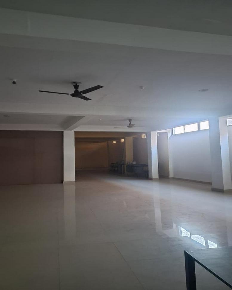 Spacious, white open-plan office area at Ranchi-Jamshedpur Road, Kokar, Ranchi, India with ceiling fans and natural light.