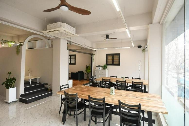 Spacious communal lounge and dining area at BASE21, 513 Suyeong-ro, Gwangalli, Busan, South Korea.