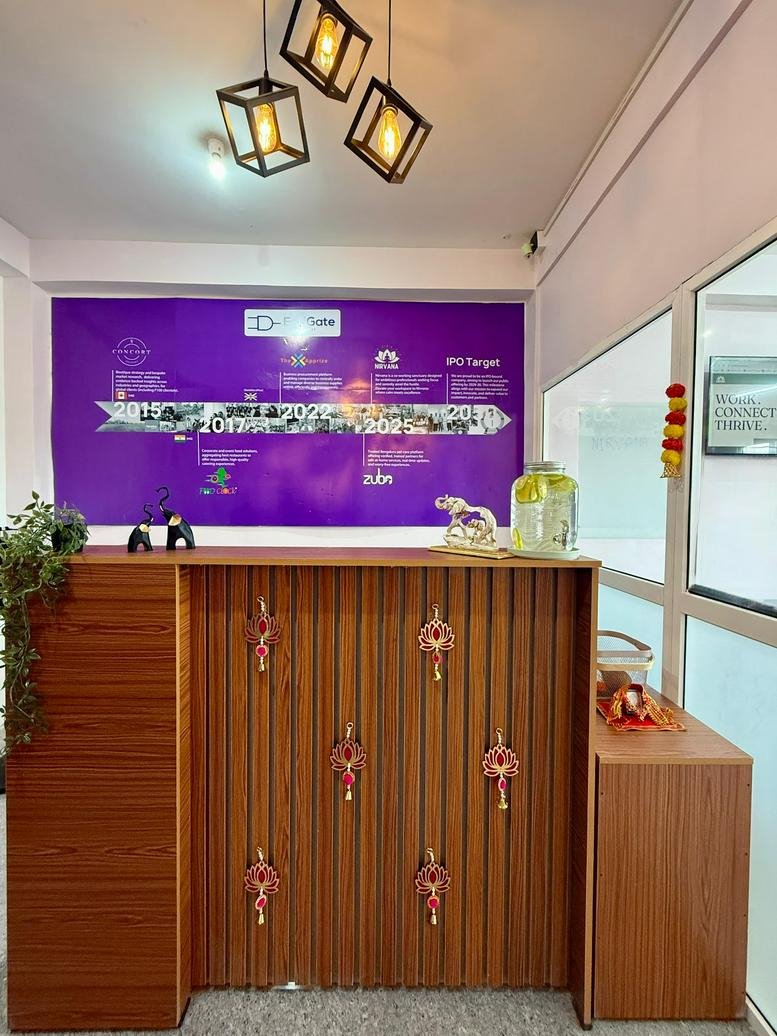 Wooden reception desk at DC Tower with purple branding wall, decorative accents, and geometric pendant lights.