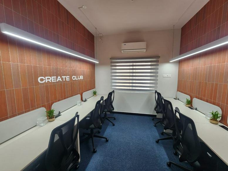 Open-plan workspace with two rows of desks, ergonomic chairs, and wood-paneled walls.