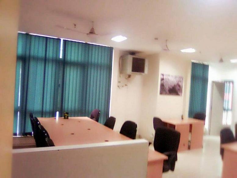Spacious shared workspace at EN Block, Sector 5, Bidhannagar with several desks and teal vertical blinds.