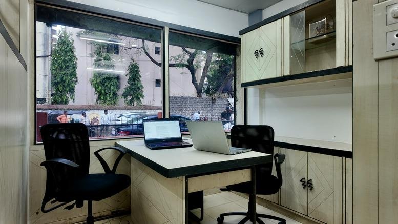 Private office with two workstations and a window view at Girish, 1156, Shukrawar Peth, Pune - 411002.
