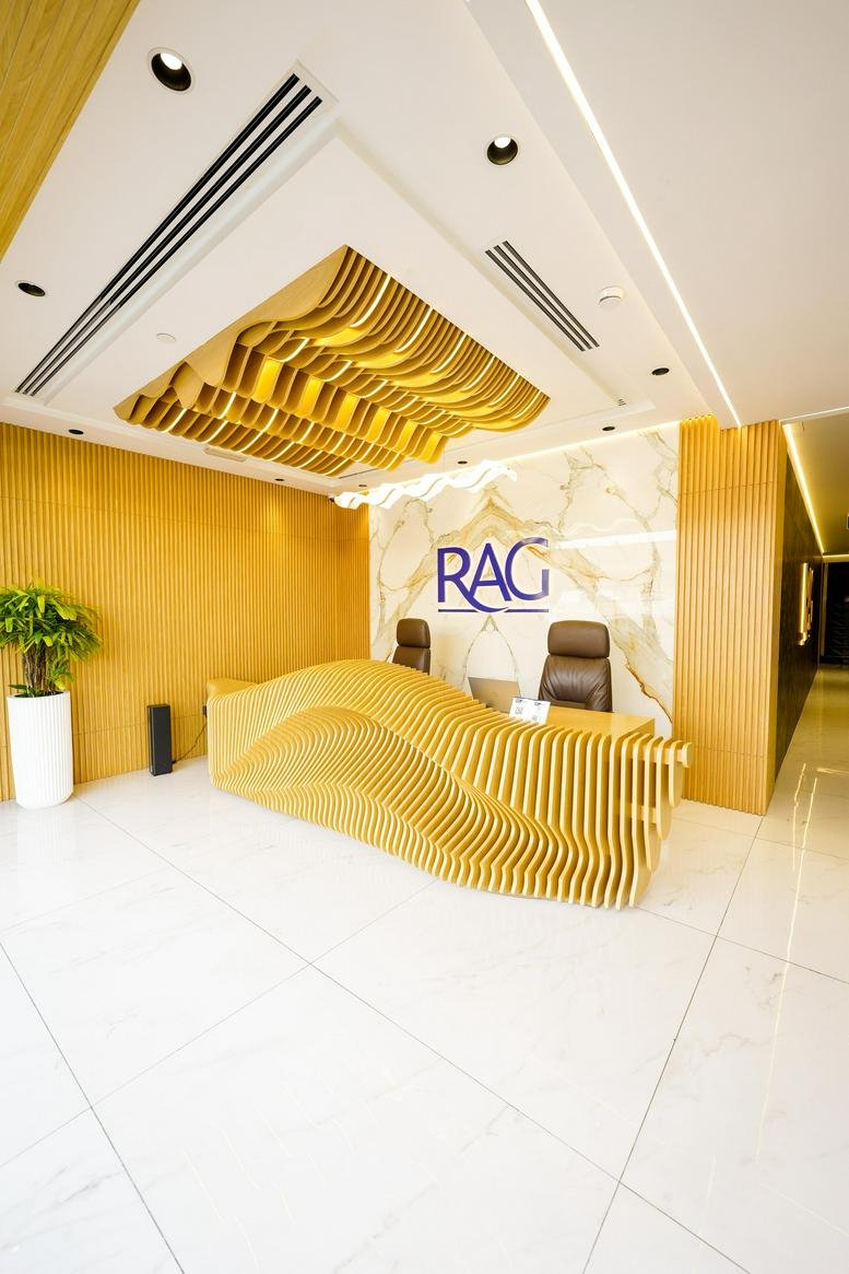 Reception area with modern wooden design and RAG logo.