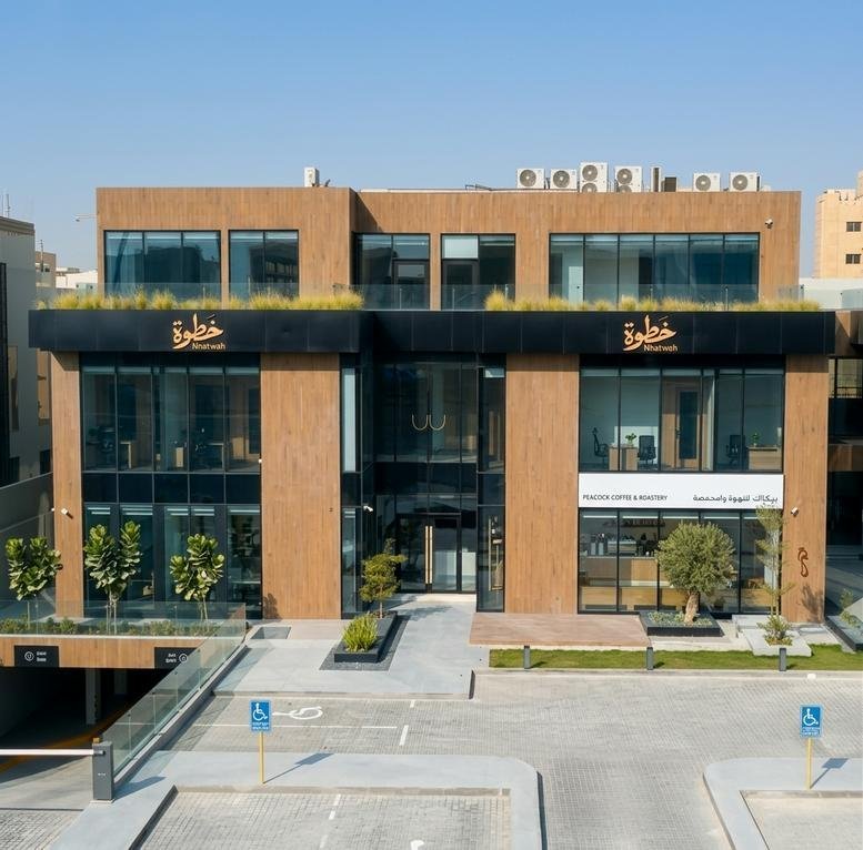Exterior view of the wood-clad and glass facade building at King Abdul Aziz Branch Road,Al Yasmin District.