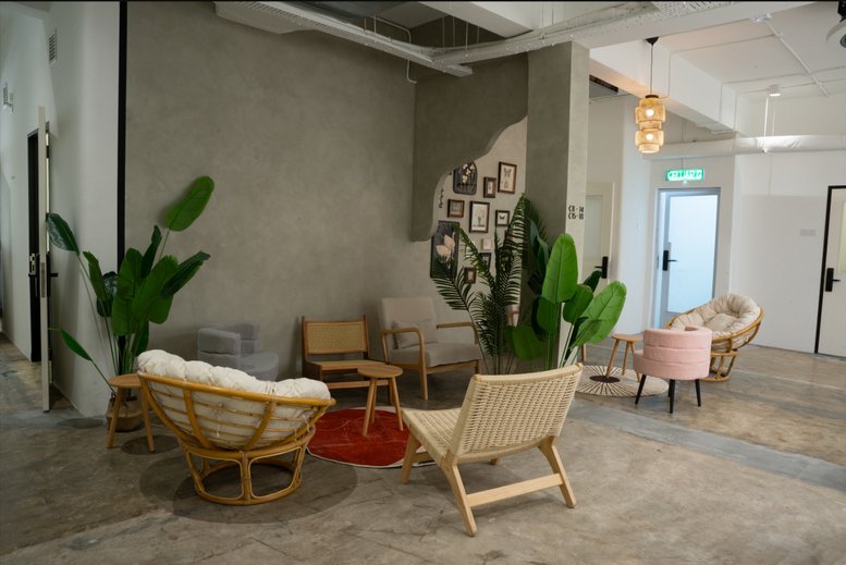 Spacious communal lounge at Level 1, 11 & 15, Jalan Permas Jaya 10/1 with eclectic seating and potted plants.