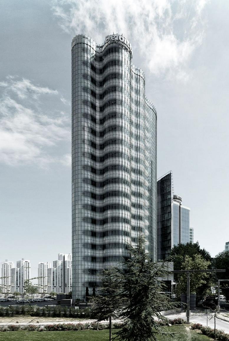 Exterior view of the wave-patterned glass facade at As Plaza.
