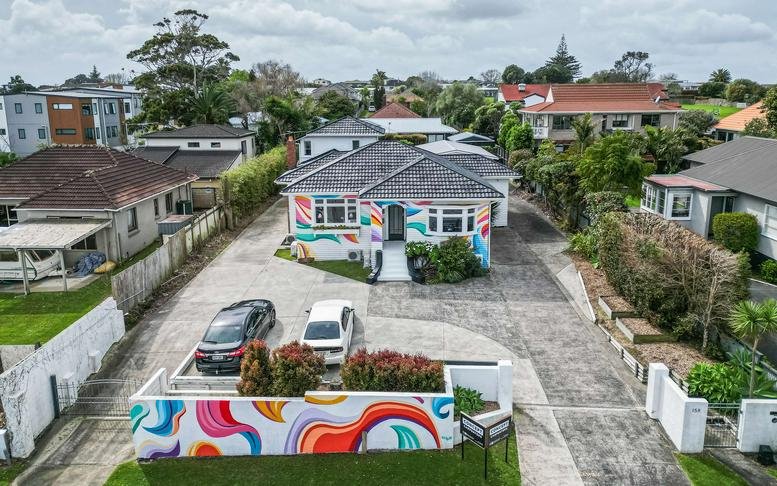 Exterior view of the colorful mural-painted building at 158, Lake Road, Belmont, Auckland.