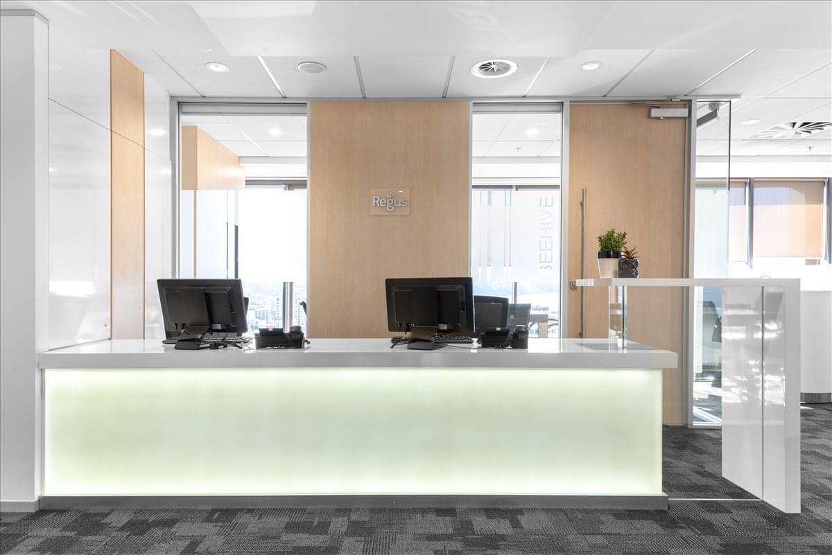 Professional white reception desk with integrated lighting and minimalist decor.