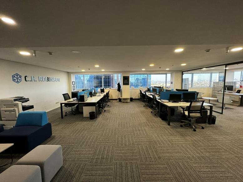 Spacious open-plan workspace at 3, Maslak Meydan Sokak with desks and city views through large windows.