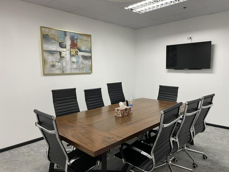 Spacious meeting room at 6000, I. Villa Street, Cebu with a large wooden table and modern black chairs.