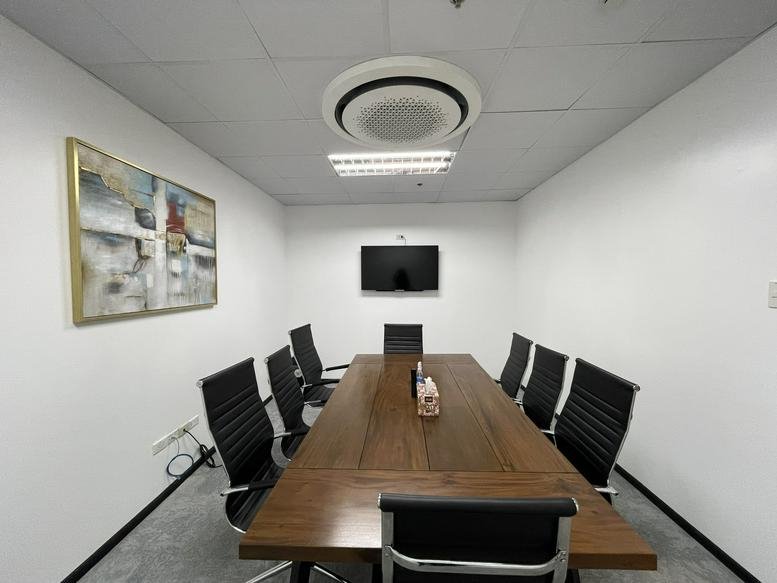 Professional boardroom at 6000, I. Villa Street, Cebu featuring a long wooden table and abstract art.