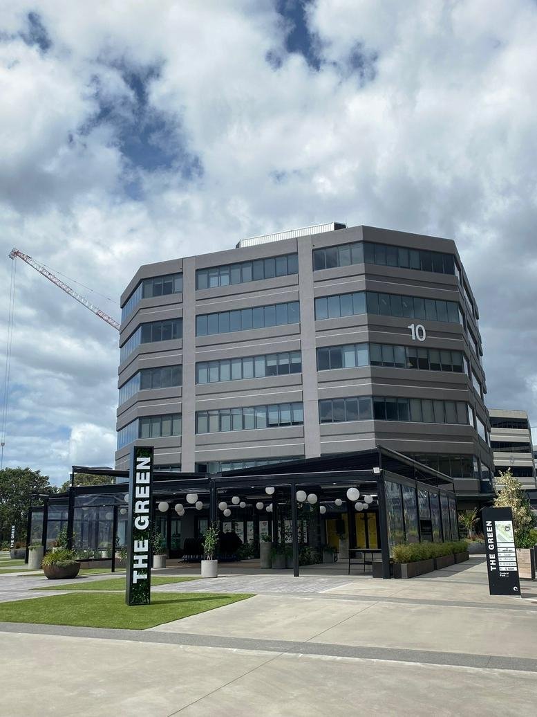 Exterior view of the multi-story Building 10 Level 3, 666 Great South Road with outdoor seating.