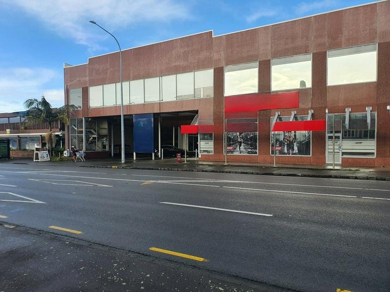 Exterior view of the brick-clad retail and office building at 711 Mount Albert Road.
