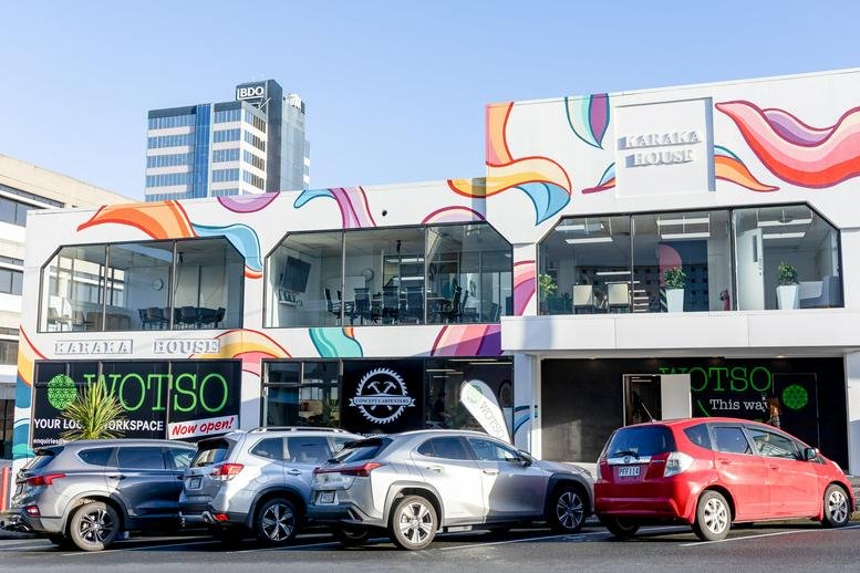 Exterior view of the colorful mural-covered building at 9 Huron Street, Auckland.