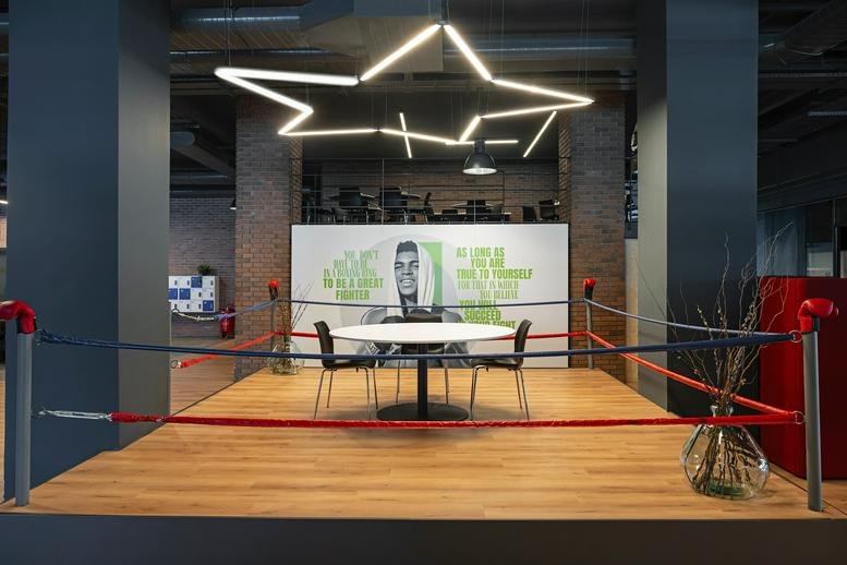 Spacious communal hub with star-shaped overhead lighting and a boxing-themed meeting area.