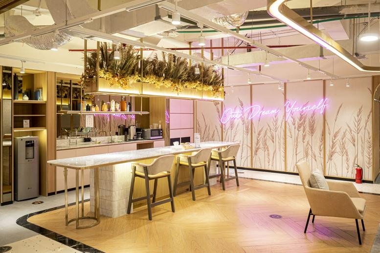 Communal lounge and pantry area at Central Park Mall, LG Floor with neon signage and wooden finishes.