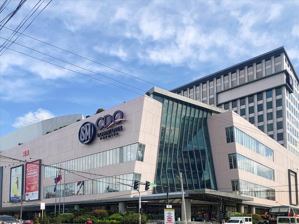 Exterior view of the modern glass and stone facade of the SM CDO Downtown Tower.