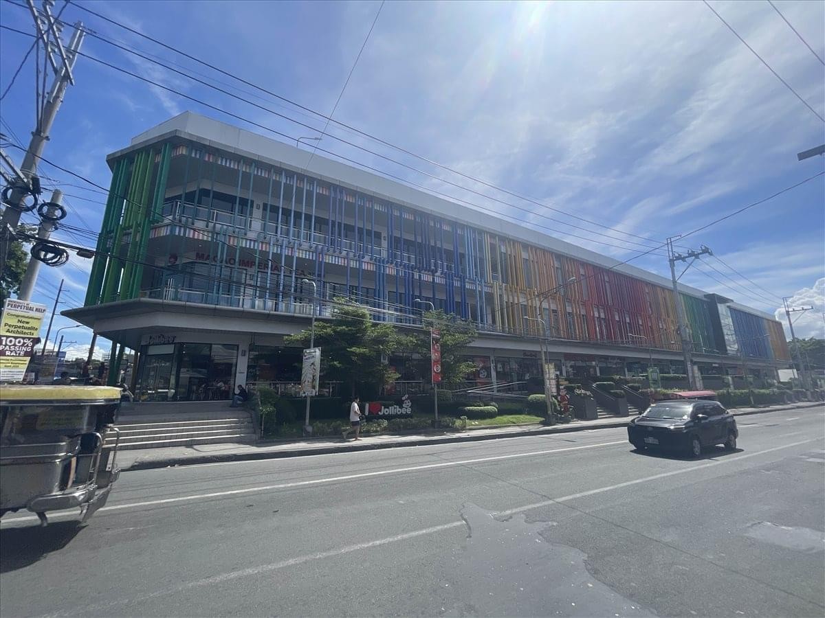 Exterior view of the colorful glass-facade building at Colours Town Center.