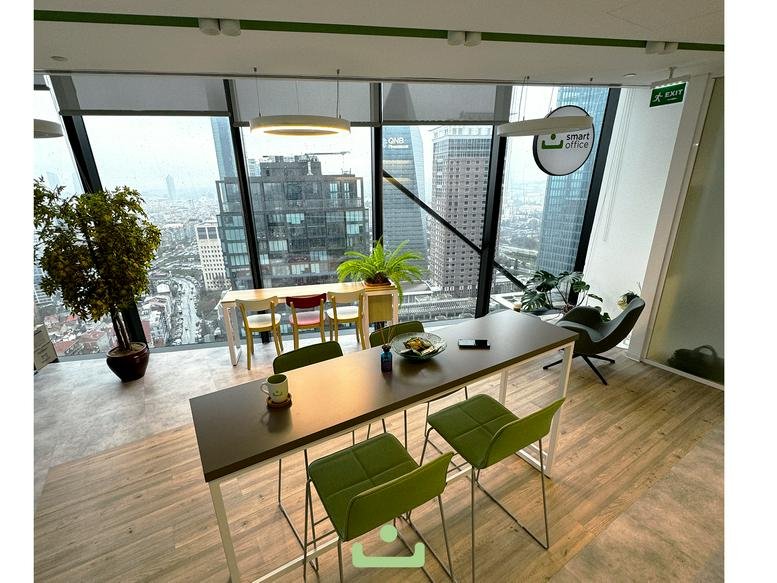 Sleek dining area with high tables, green stools, and floor-to-ceiling windows.