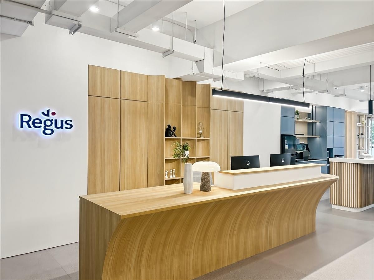 Reception desk at Fordham Street, AMA Tower featuring a curved wood design and bright branding.