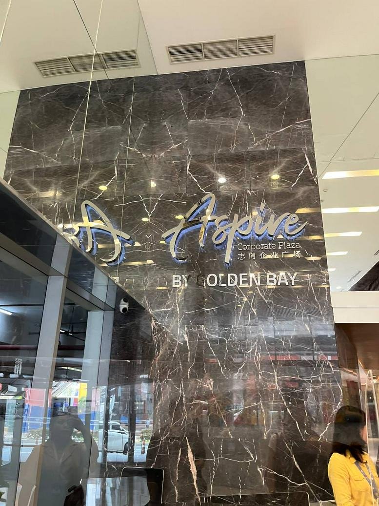 Exterior view of Aspire Corporate Plaza by Golden Bay with glass facade entrance.