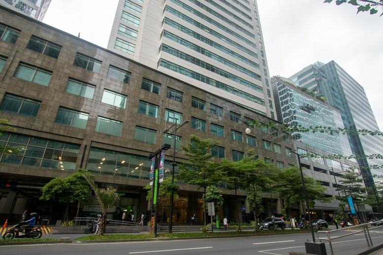 Exterior view of the towering glass and stone facade of the IBM Plaza, Eastwood, Quezon City.