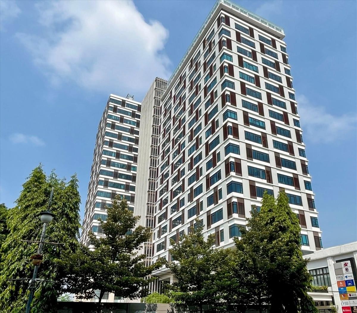 Exterior view of the high-rise glass-facade HQuarters building in Bandung.
