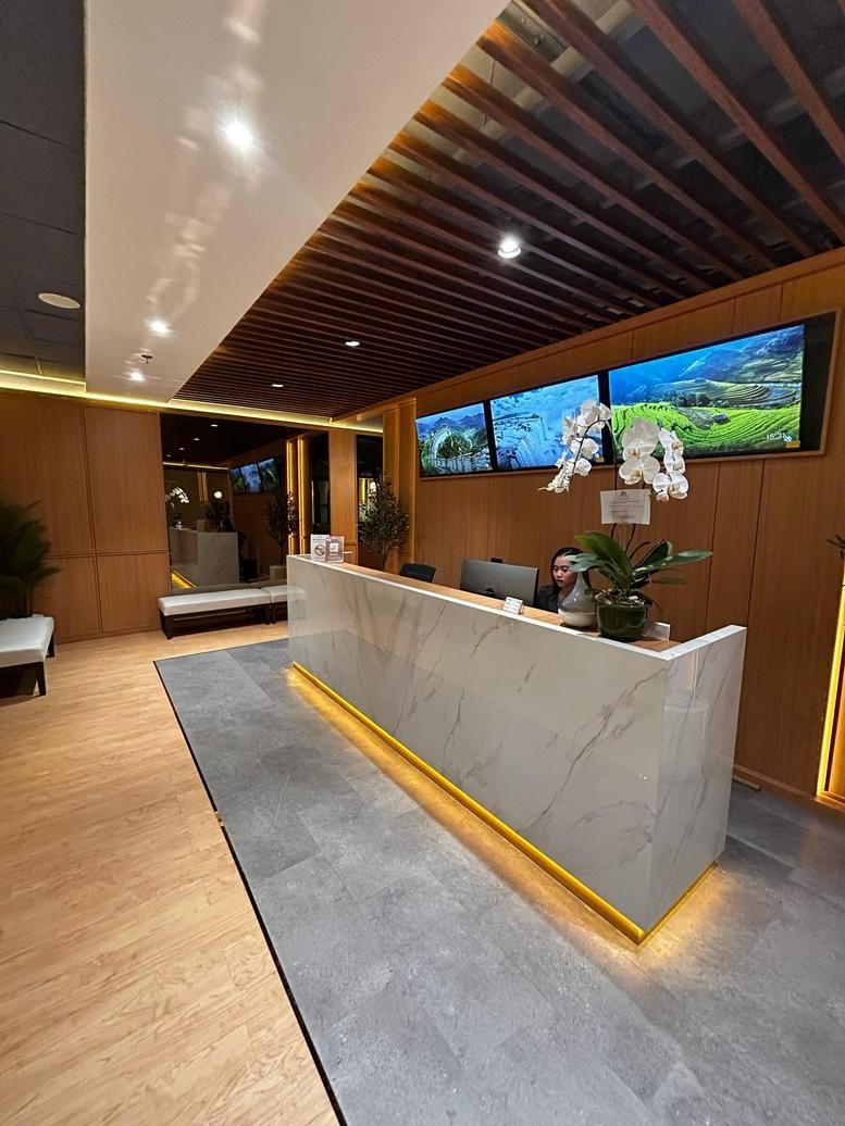 Polished marble reception desk at Jl HR Rasuna Said Kav. x-7 No. 6 under a slatted wood ceiling.