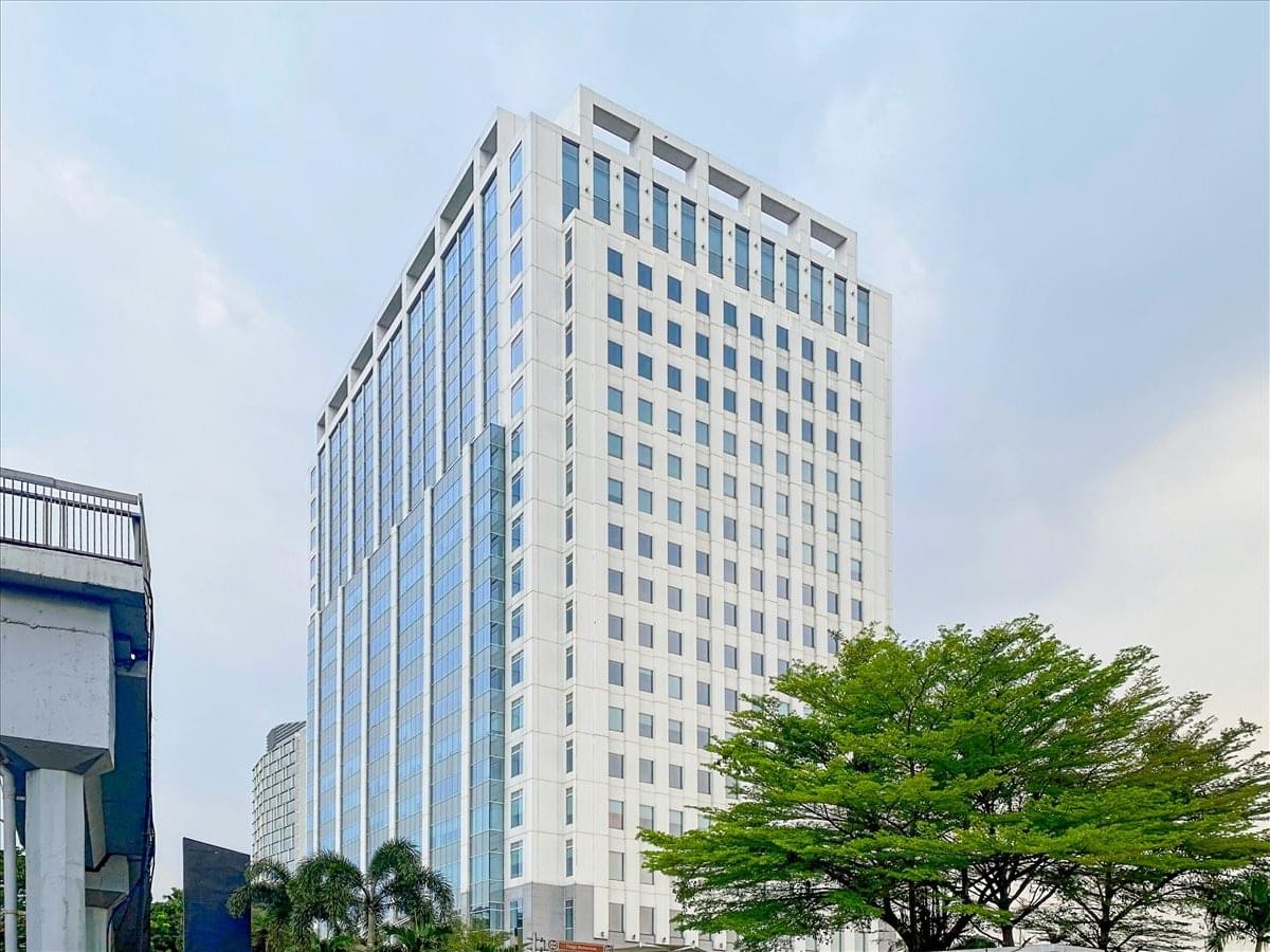 Wide exterior shot of the multi-story glass facade office building.