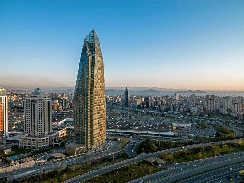 Exterior view of the glass-facade Allianz Tower standing prominently in the city skyline.