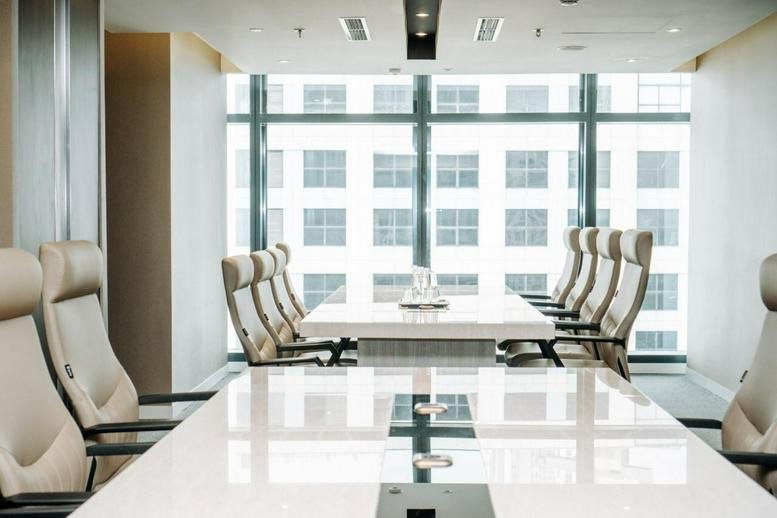 Modern boardroom at Sudirman 7. 8, Level 16 featuring high-back leather chairs and city views.