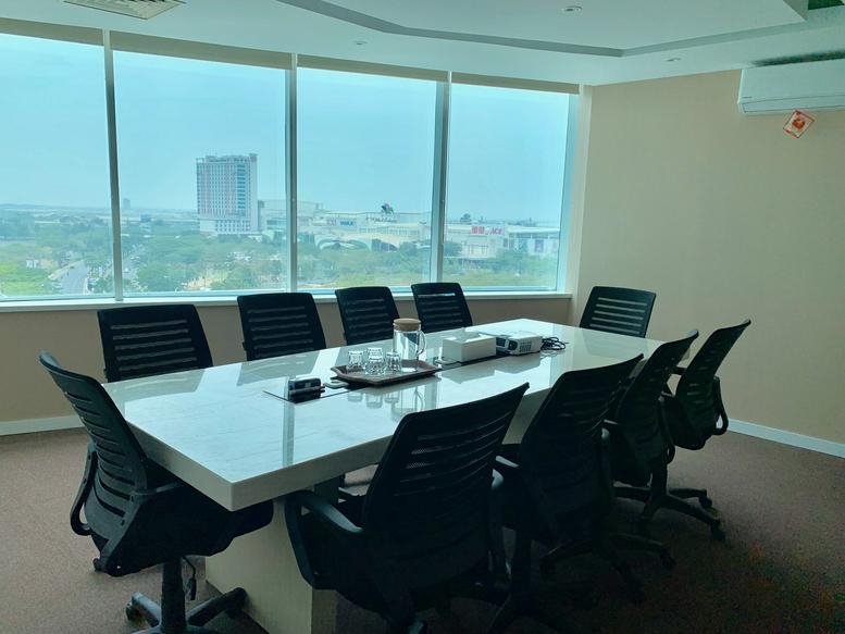 Spacious boardroom at Plaza Summarecon Level 7 with white table and expansive city views.
