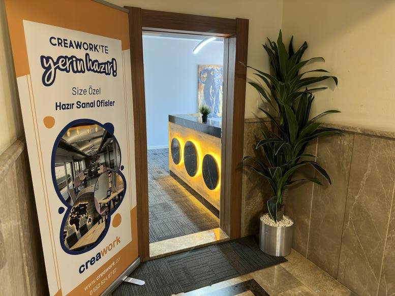 Entrance to the Muratpaşa antalya, Antalya office featuring a branded banner and wooden doorway.