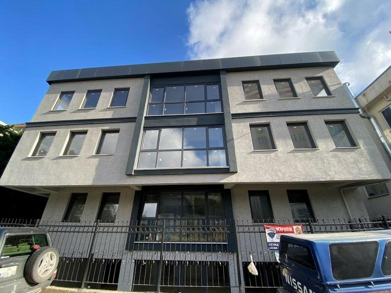 Exterior view of the grey and black facade building at İnkılap, Umman Sk. 2-4, Istanbul.