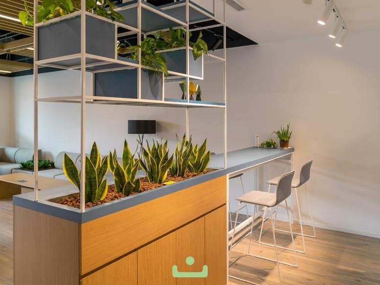 Modern breakout area with tiered wooden planters and snack bar at Bulvar 216 AVM No: 4.