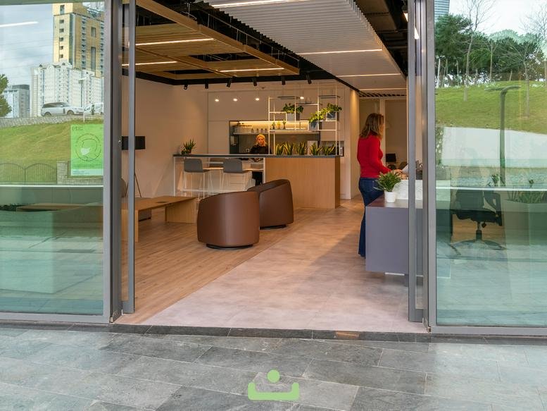 Spacious reception and lounge area at Bulvar 216 AVM No: 4 with wooden floors and glass walls.
