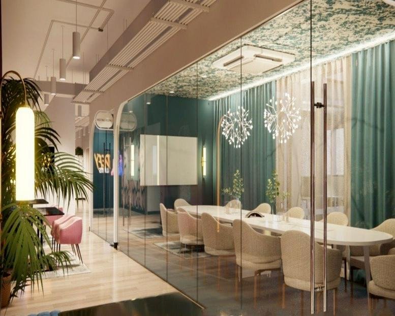 Bright glass-enclosed meeting room with a long white table, cream chairs, and teal curtains.