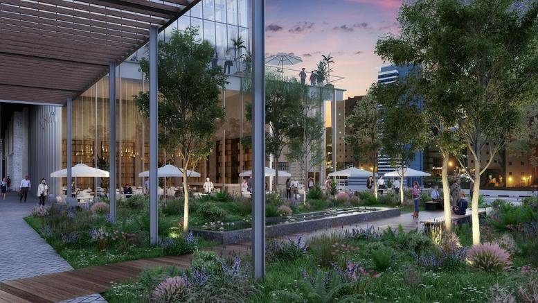 Evening view of the landscaped garden and glass facade at One Tower, 21 Abba Hillel Street.