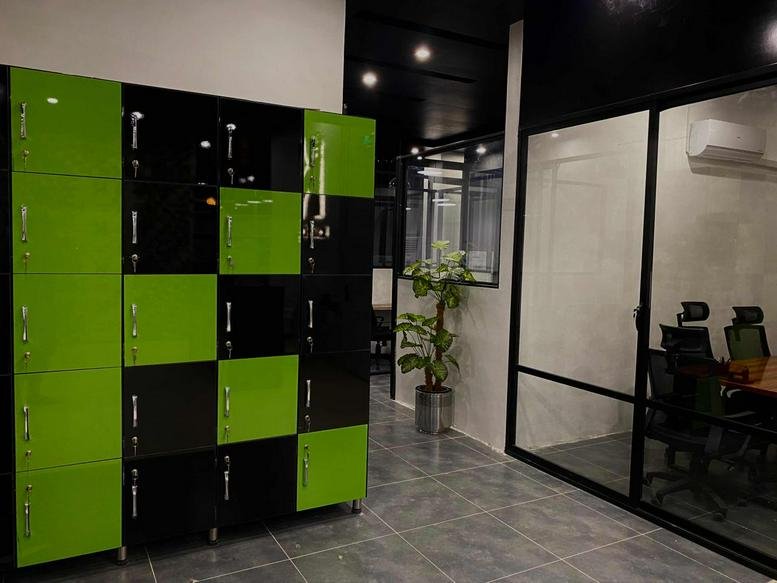 Reception area at Al Taqwa Mall with vibrant green and black checkered storage lockers and glass partitions.