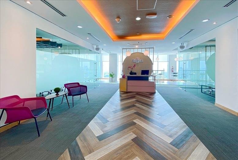 Welcoming entrance area with purple guest chairs and glass partitions.