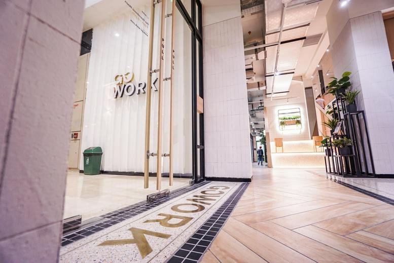 Modern entrance to the Plaza Indonesia serviced offices featuring light wood floors and glass doors.