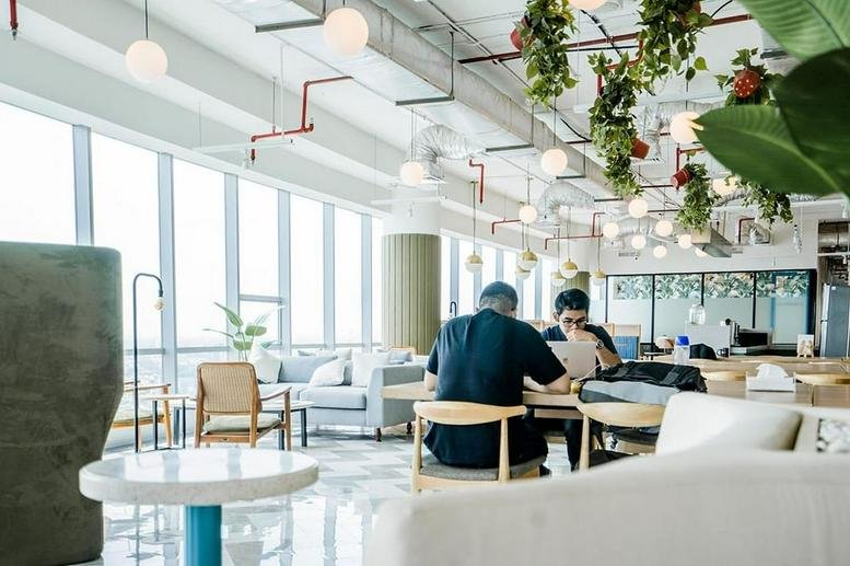 Bright open-plan workspace at Pondok Indah Office Tower 2, 15th Floor, Jakarta, Indonesia with greenery and city views.