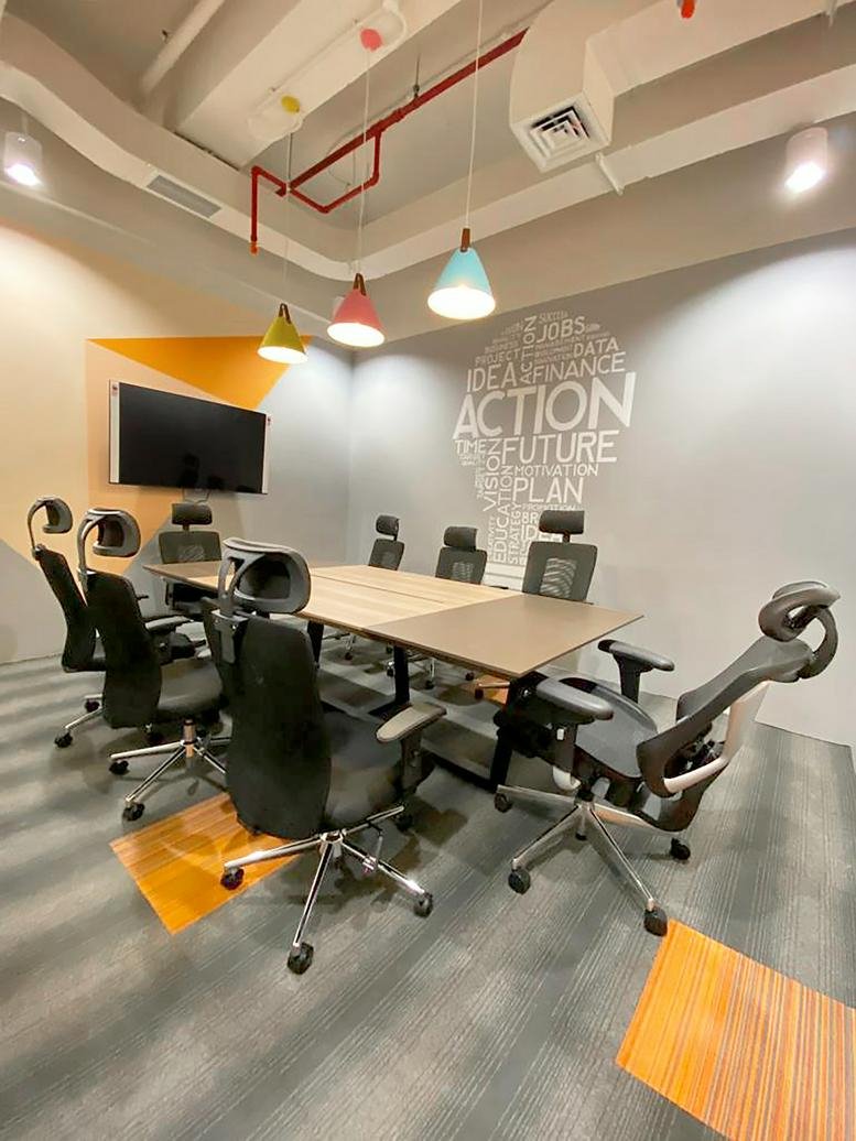 Meeting room at Treasury Tower, Level 5 Unit J, with colorful pendant lights and wall graphics.