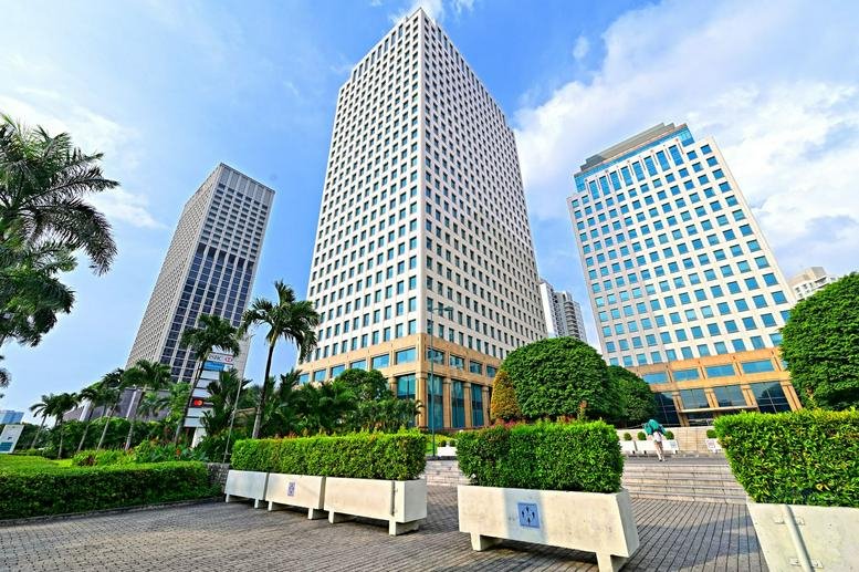 Exterior view of the contemporary multi-story Sentral Senayan II office towers with manicured hedges.